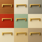 Dallas 128 mm RVS Goud Set 20 decorative handles in various colors on drawer backgrounds.